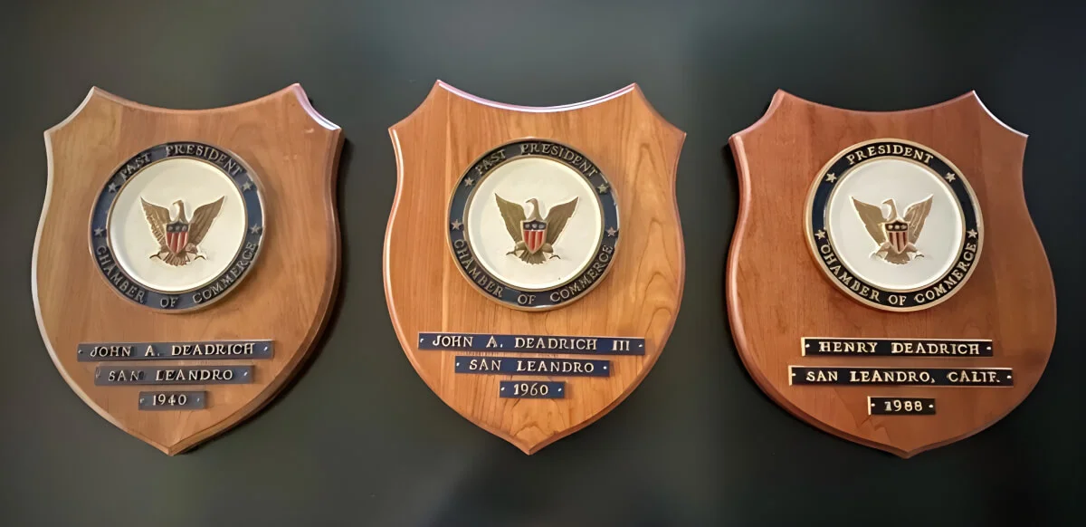 Three wooden plaques with a seal on them.