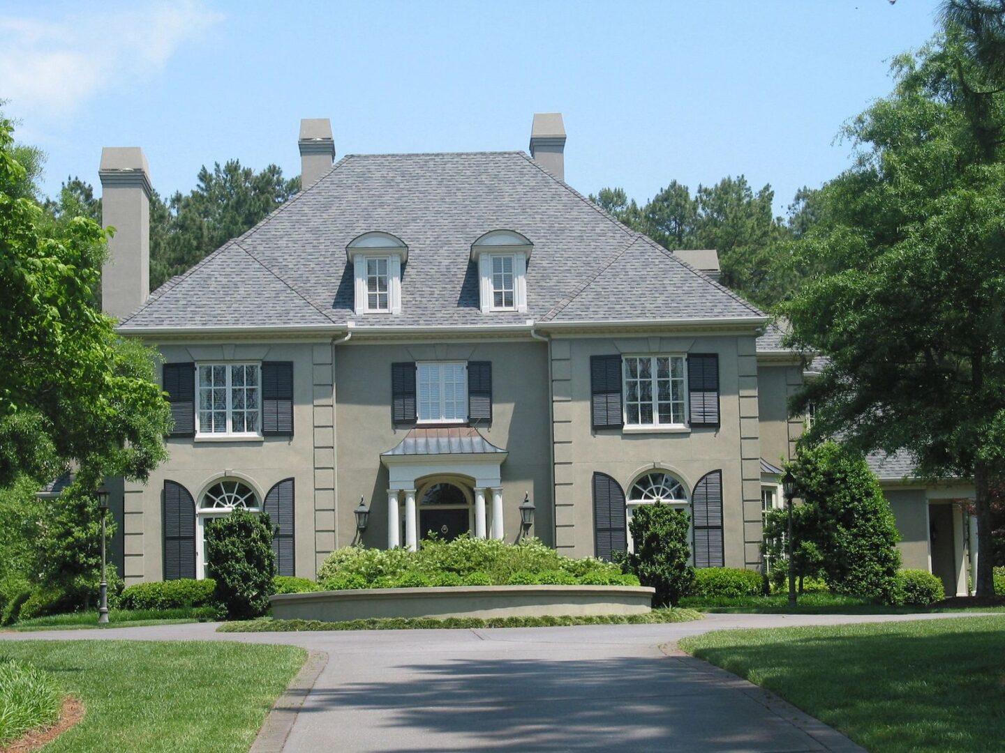A large house with a driveway in front of it.